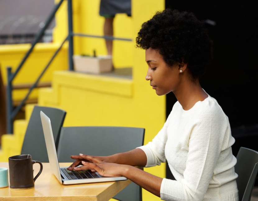 demo-attachment-1082-attractive-young-woman-using-laptop-outside-P9RLFGU@2x